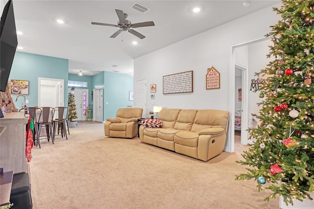 living room featuring light carpet and ceiling fan