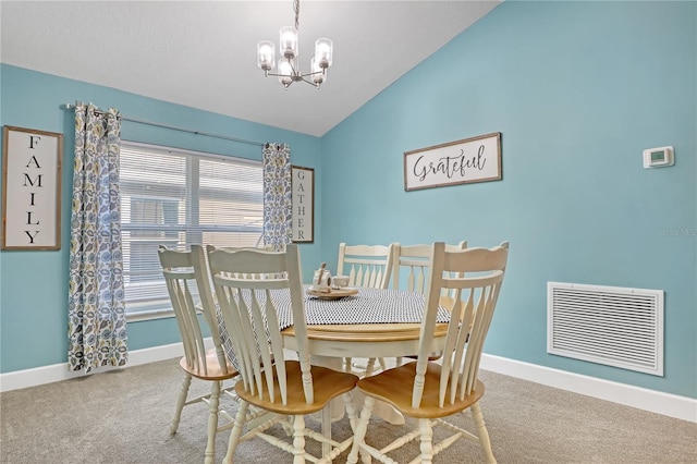 dining room with carpet, vaulted ceiling, and a notable chandelier