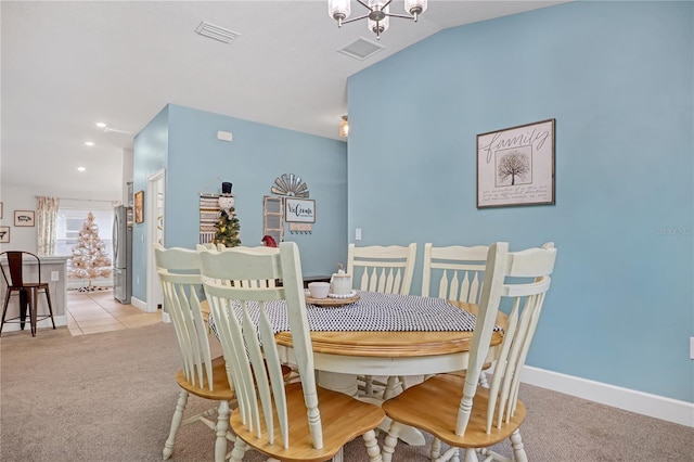 dining room with a notable chandelier and light carpet