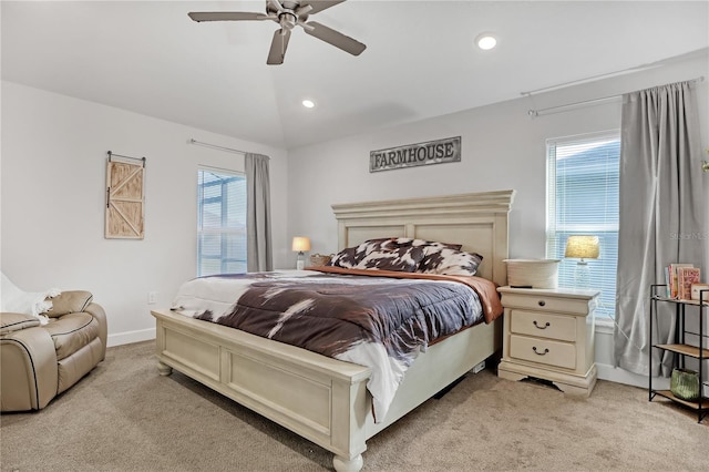 carpeted bedroom with ceiling fan, lofted ceiling, and multiple windows