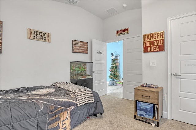 bedroom with light colored carpet and vaulted ceiling