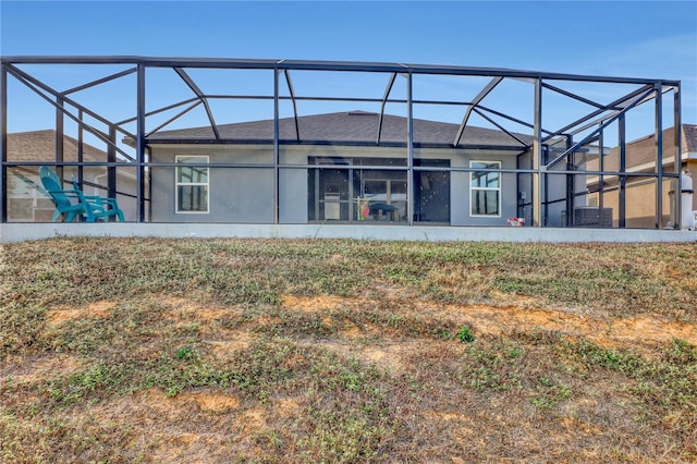 back of property featuring a lanai