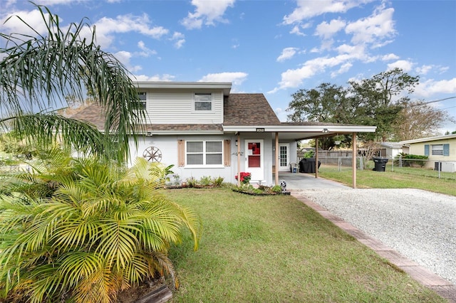 view of front of home with a carport and a front lawn