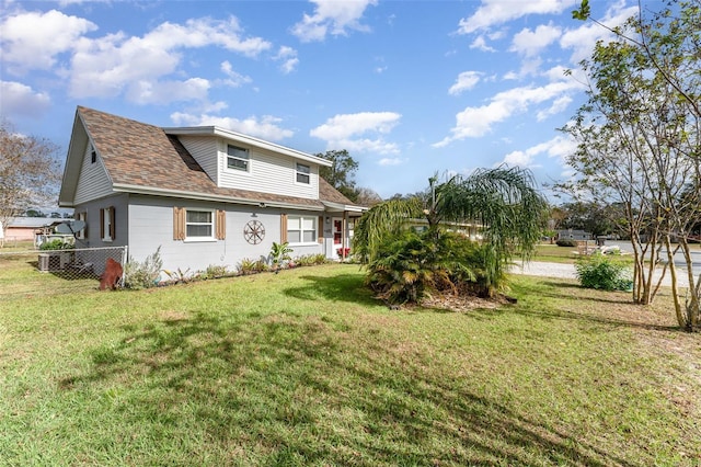 rear view of property with a yard