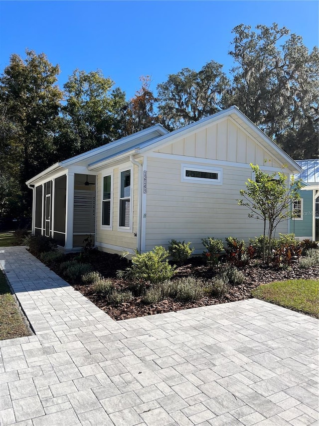 view of side of home with a sunroom