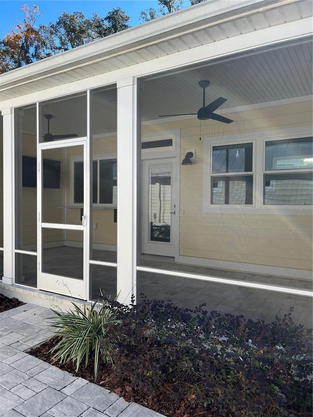 doorway to property with ceiling fan