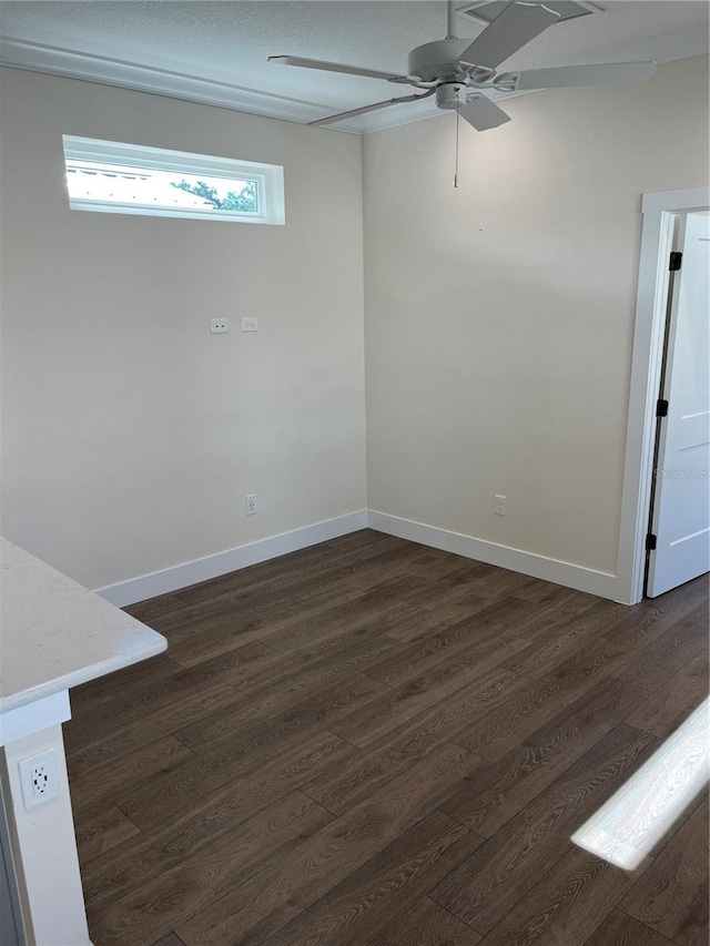 spare room with ceiling fan and dark hardwood / wood-style flooring