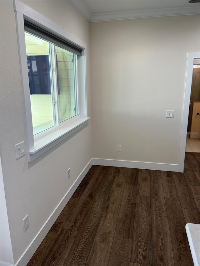 spare room with dark hardwood / wood-style floors and ornamental molding