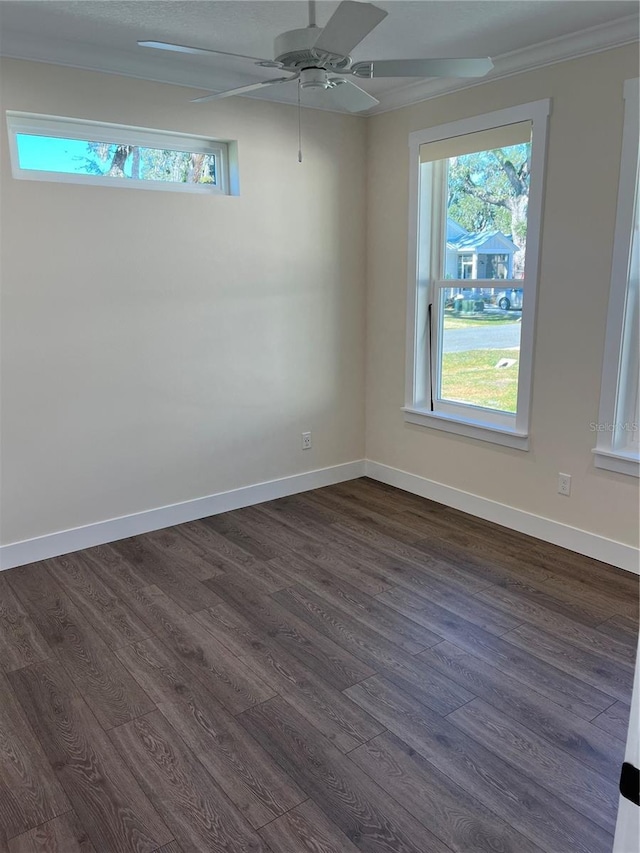 spare room featuring ceiling fan, crown molding, and dark wood-type flooring