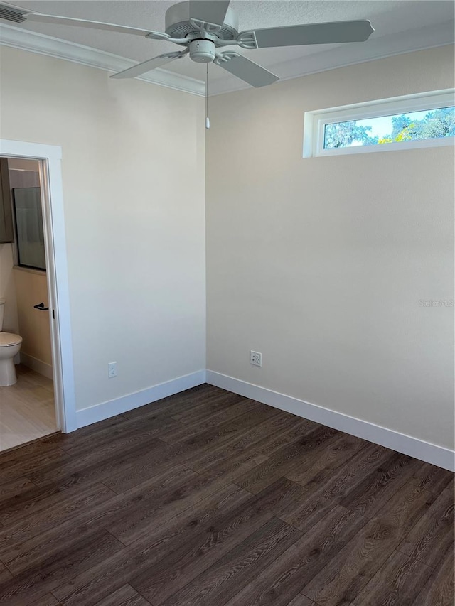 unfurnished room with ceiling fan, ornamental molding, and dark wood-type flooring