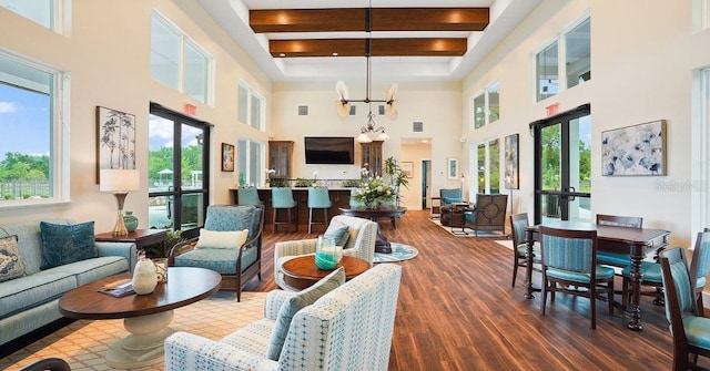 living room with a towering ceiling and a healthy amount of sunlight