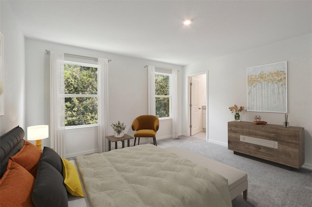 carpeted bedroom with ensuite bathroom and multiple windows