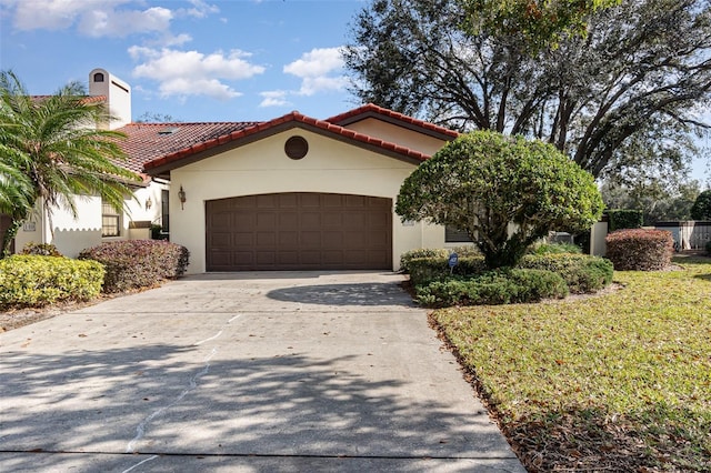 mediterranean / spanish house featuring a garage