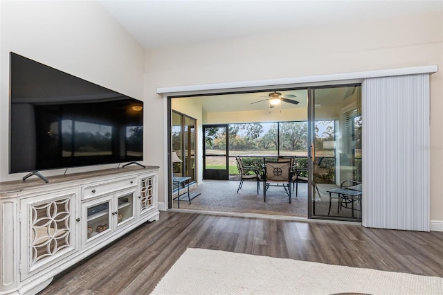 unfurnished living room with ceiling fan and dark hardwood / wood-style floors