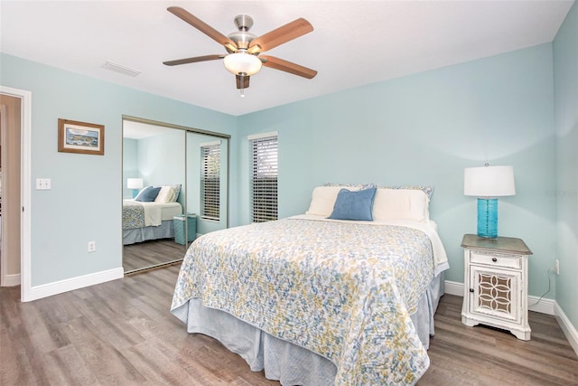 bedroom featuring ceiling fan, a closet, and wood-type flooring