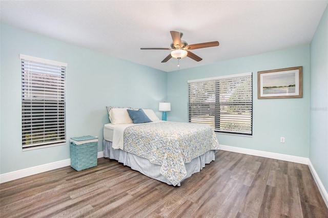 bedroom featuring multiple windows, ceiling fan, and hardwood / wood-style floors