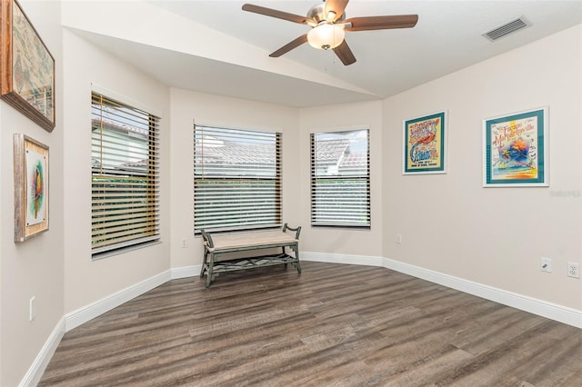 living area with dark hardwood / wood-style flooring, vaulted ceiling, and ceiling fan