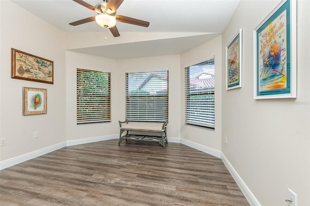 unfurnished room featuring dark hardwood / wood-style floors, vaulted ceiling, and ceiling fan