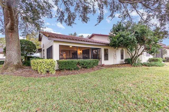 mediterranean / spanish house with a front lawn