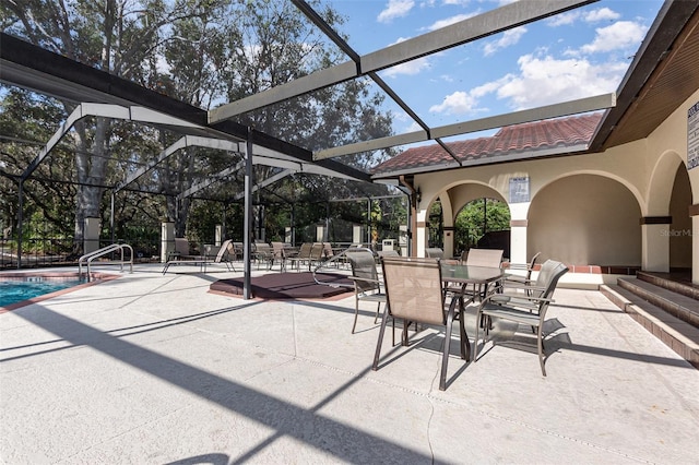 view of patio / terrace featuring a lanai and a community pool