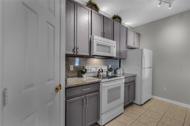 kitchen with decorative backsplash, light tile patterned floors, white appliances, and gray cabinets