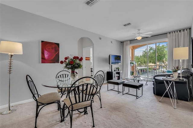 dining room featuring light colored carpet and ceiling fan