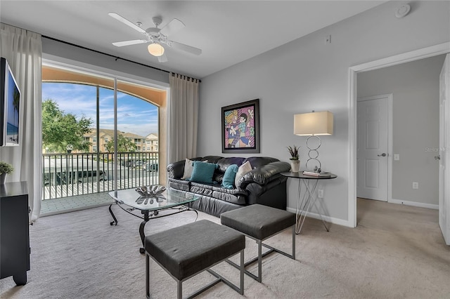 carpeted living room featuring ceiling fan