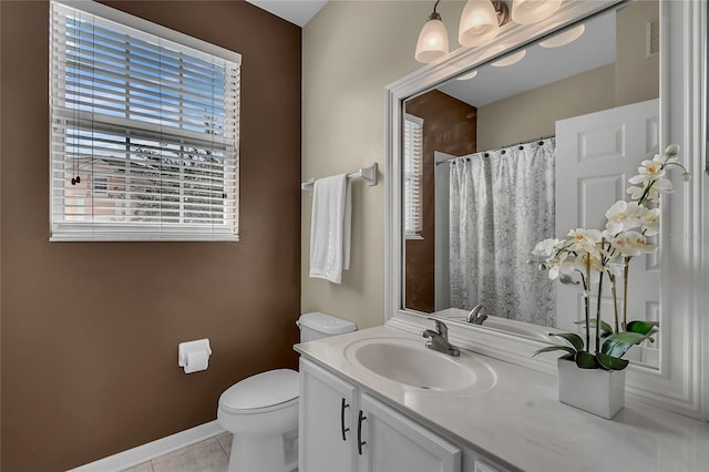 bathroom featuring tile patterned flooring, a shower with curtain, vanity, and toilet