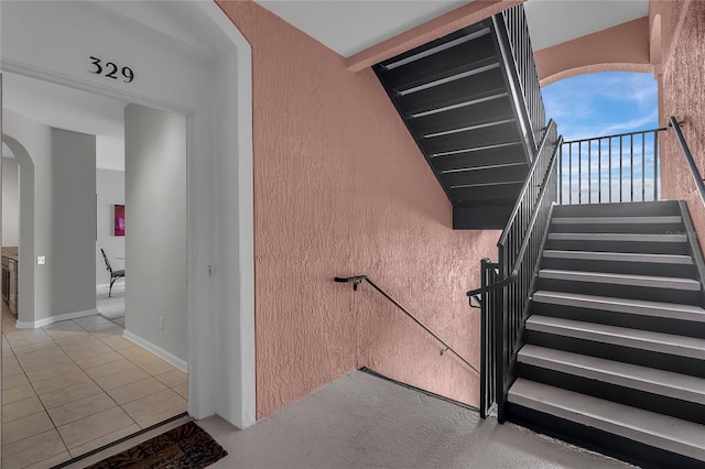 stairs featuring tile patterned flooring