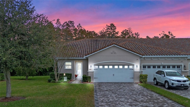 view of front facade with a yard and a garage