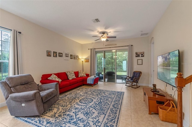 living room with ceiling fan and light tile patterned floors