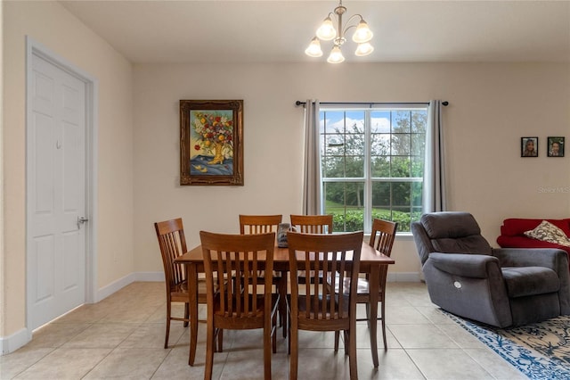 tiled dining room with a healthy amount of sunlight and a chandelier