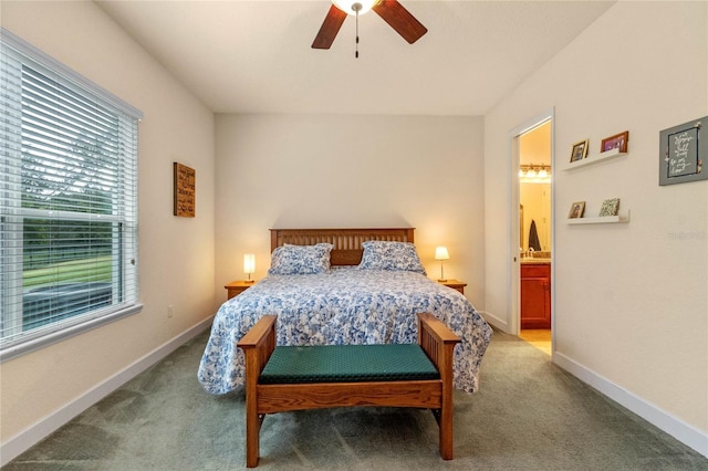 bedroom with ensuite bathroom, ceiling fan, and light carpet