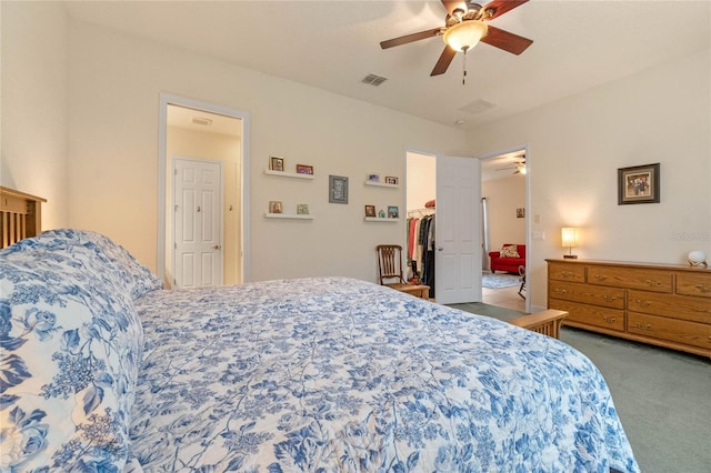 bedroom with a walk in closet, ceiling fan, a closet, and carpet floors