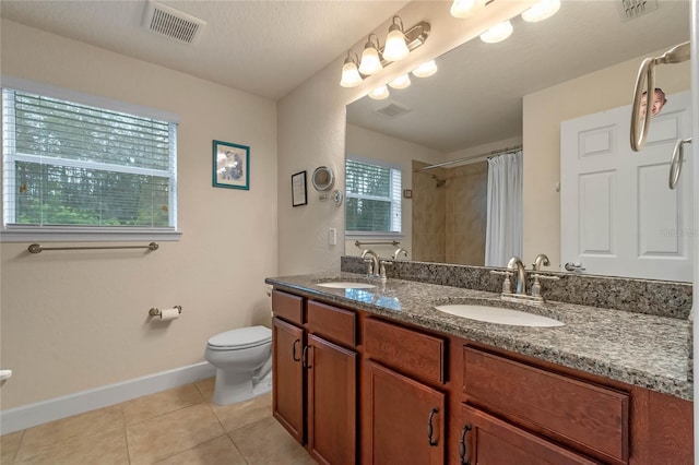 bathroom with a shower with curtain, tile patterned floors, a textured ceiling, toilet, and vanity