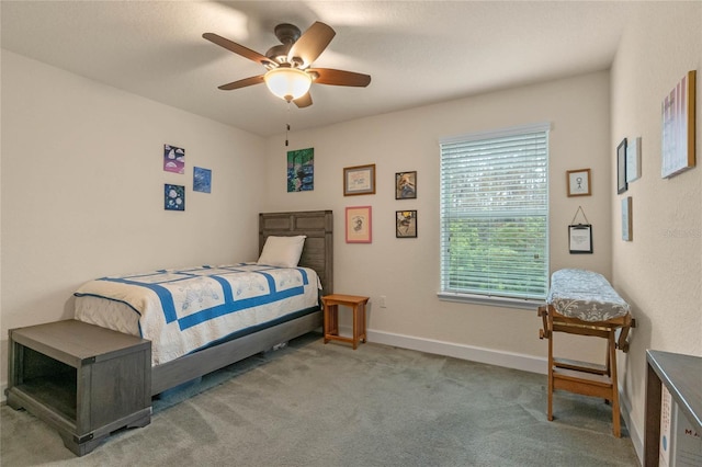 carpeted bedroom featuring ceiling fan and multiple windows