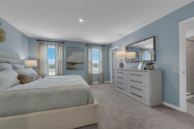 bedroom featuring light carpet and a textured ceiling