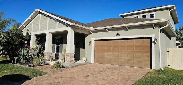 view of front of home featuring covered porch and a garage