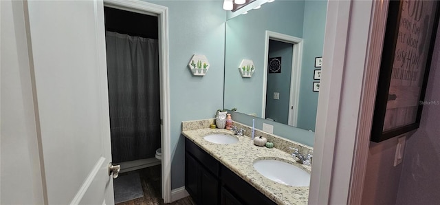 bathroom featuring hardwood / wood-style floors, vanity, toilet, and walk in shower