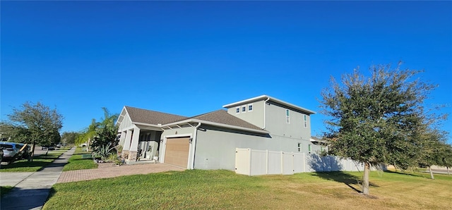 view of side of property with a yard and a garage