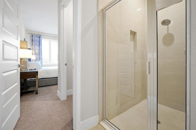 bathroom featuring a shower with door