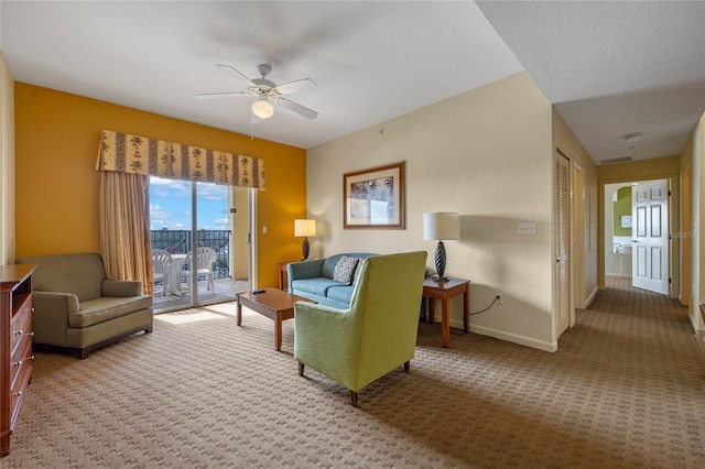 carpeted living room featuring ceiling fan