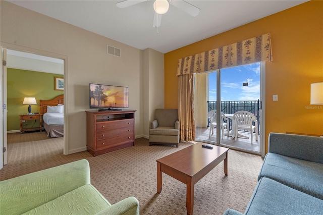 carpeted living room featuring ceiling fan