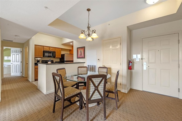 carpeted dining space with an inviting chandelier