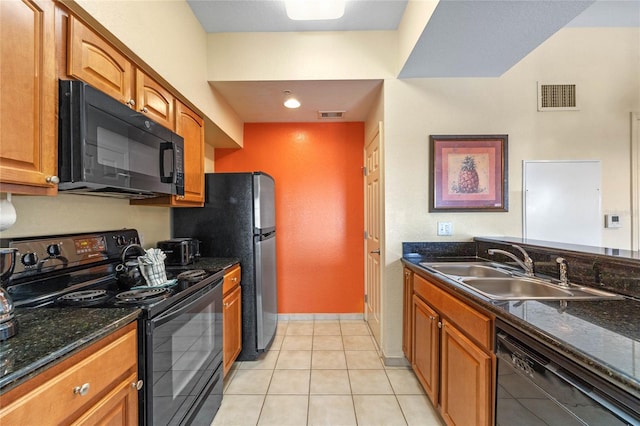 kitchen featuring light tile patterned flooring, sink, dark stone counters, and black appliances