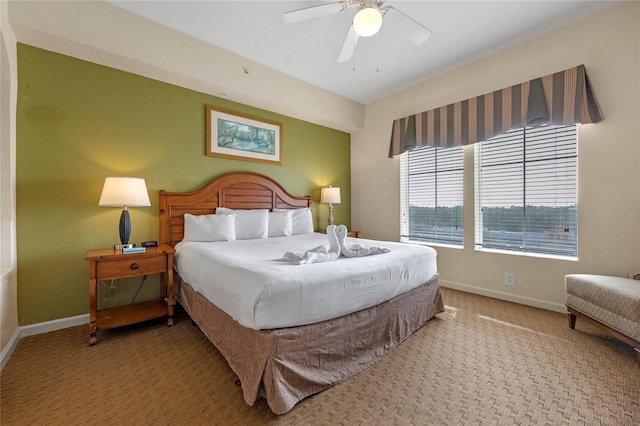 bedroom featuring ceiling fan and light carpet