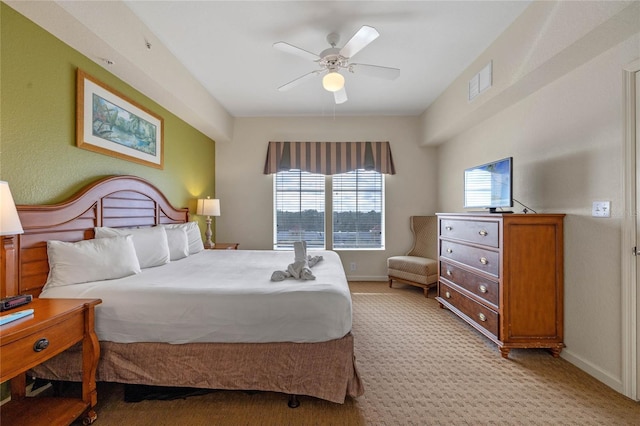 bedroom with ceiling fan and light carpet