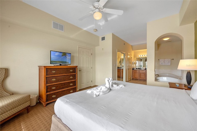 carpeted bedroom with ensuite bathroom, ceiling fan, and lofted ceiling