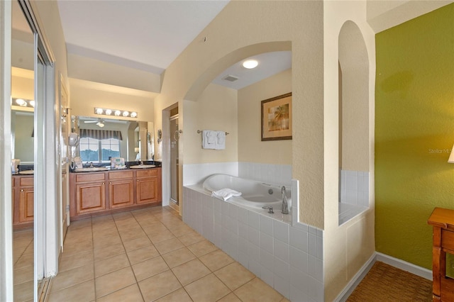 bathroom with tile patterned floors, separate shower and tub, and vanity