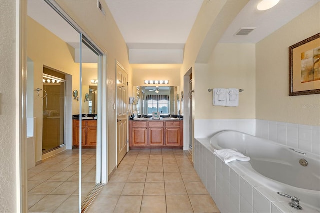 bathroom featuring tile patterned flooring, vanity, and shower with separate bathtub